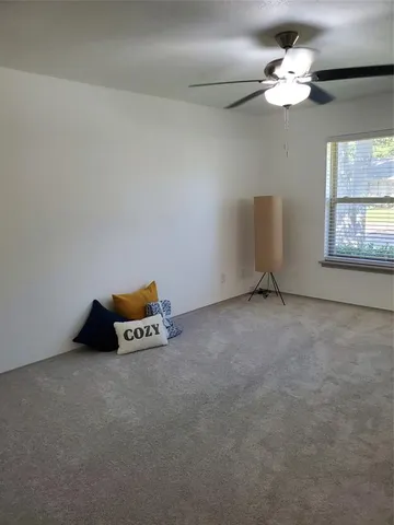 a very nice looking room with a window and a chandelier fan