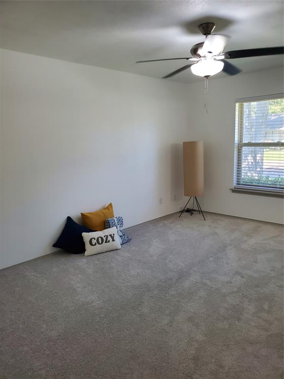 7424 Walling Lane Dallas, TX 75231 - Photo 8 of 19 a very nice looking room with a window and a chandelier fan