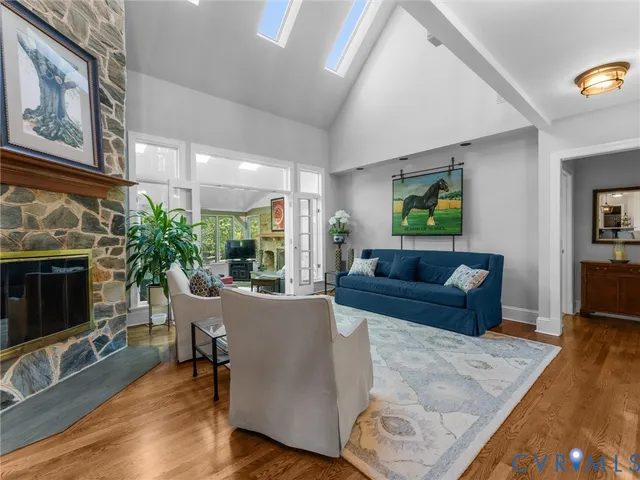 a spacious bedroom with a bed and wooden floor