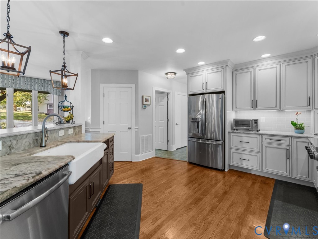 2575 Maidens Road Maidens, VA 23102 - Photo 23 of 50 a large kitchen with stainless steel appliances kitchen island granite countertop a refrigerator and a sink