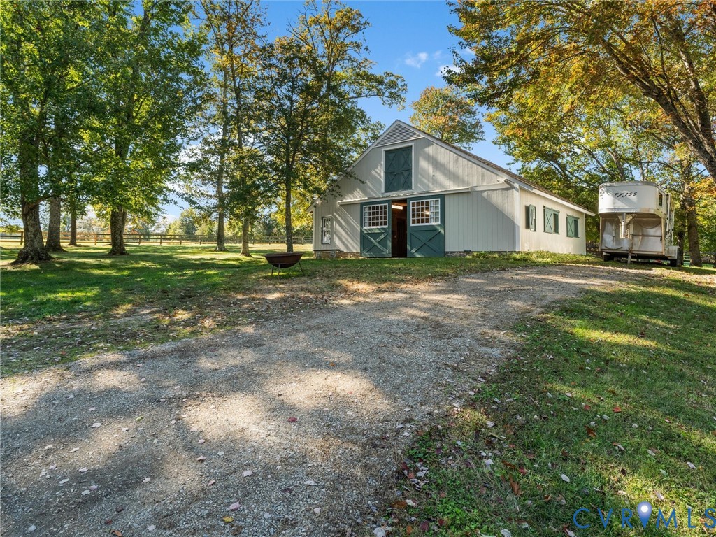 2575 Maidens Road Maidens, VA 23102 - Photo 4 of 50 a view of a yard in front of a house with large trees