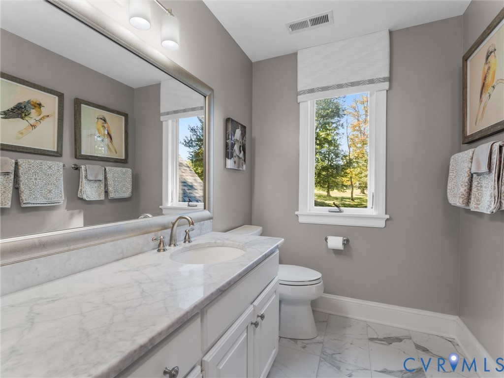 2575 Maidens Road Maidens, VA 23102 - Photo 45 of 50 a bathroom with a granite countertop sink a large mirror a toilet and a window