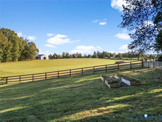 a dining room with furniture a chandelier and wooden floor