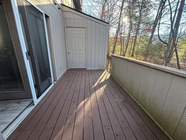 a view of balcony with wooden floor