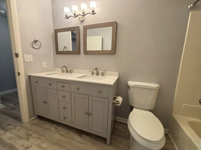 a bathroom with a toilet sink and mirror