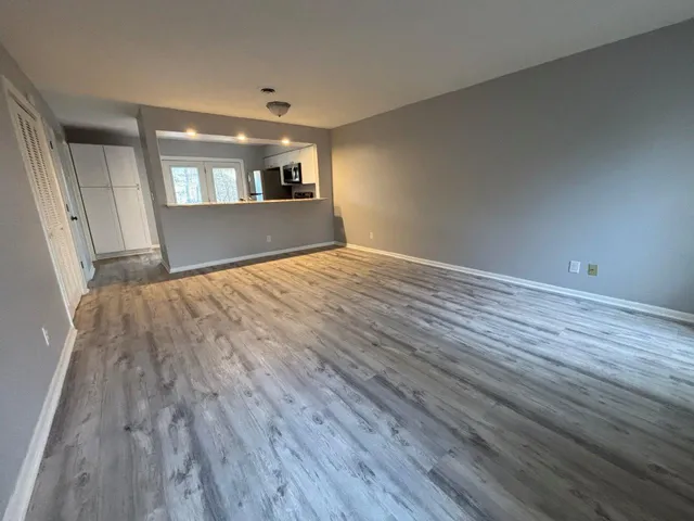 a view of wooden floor and windows in an empty room
