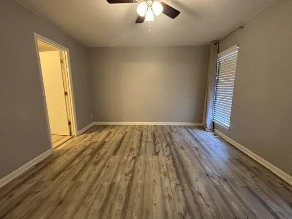 wooden floor in an empty room with a window