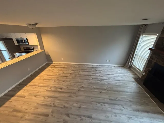 a view of an empty room and wooden floor