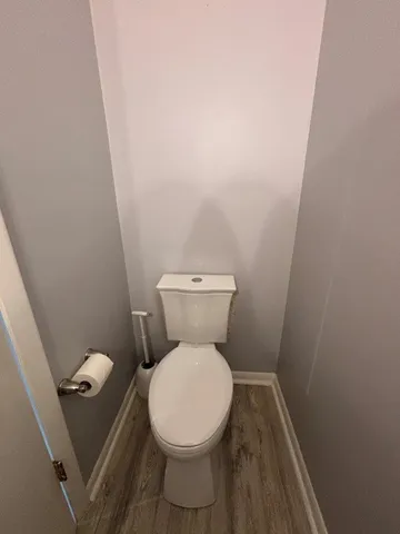a white toilet sitting next to a small sink