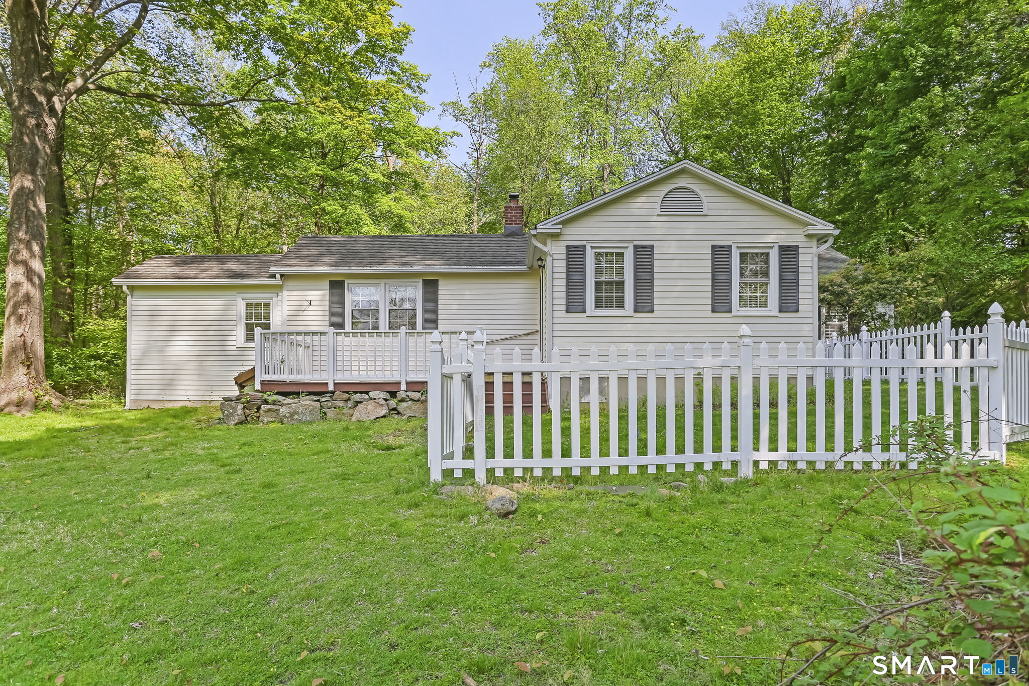 4 Topping Lane Norwalk, CT 06854 - Photo 1 of 30 a front view of a house with a garden