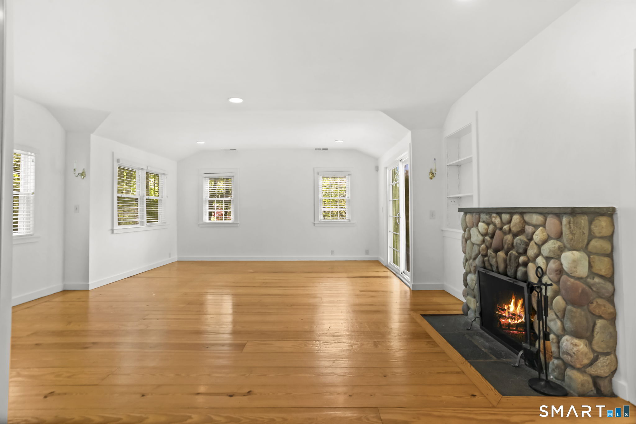 4 Topping Lane Norwalk, CT 06854 - Photo 11 of 30 a view of empty room with wooden floor and fireplace