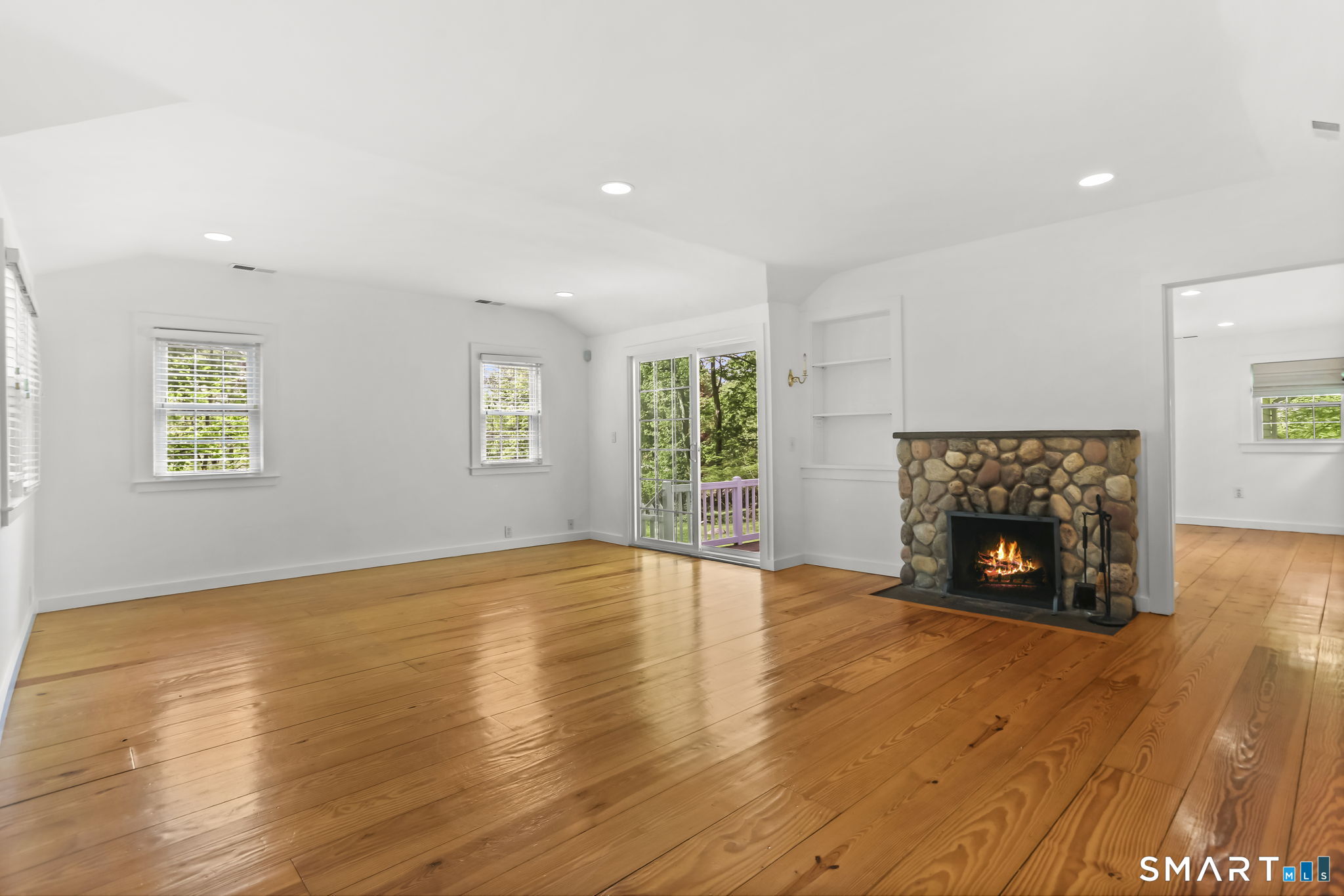 4 Topping Lane Norwalk, CT 06854 - Photo 12 of 30 a view of an empty room with a window and fireplace