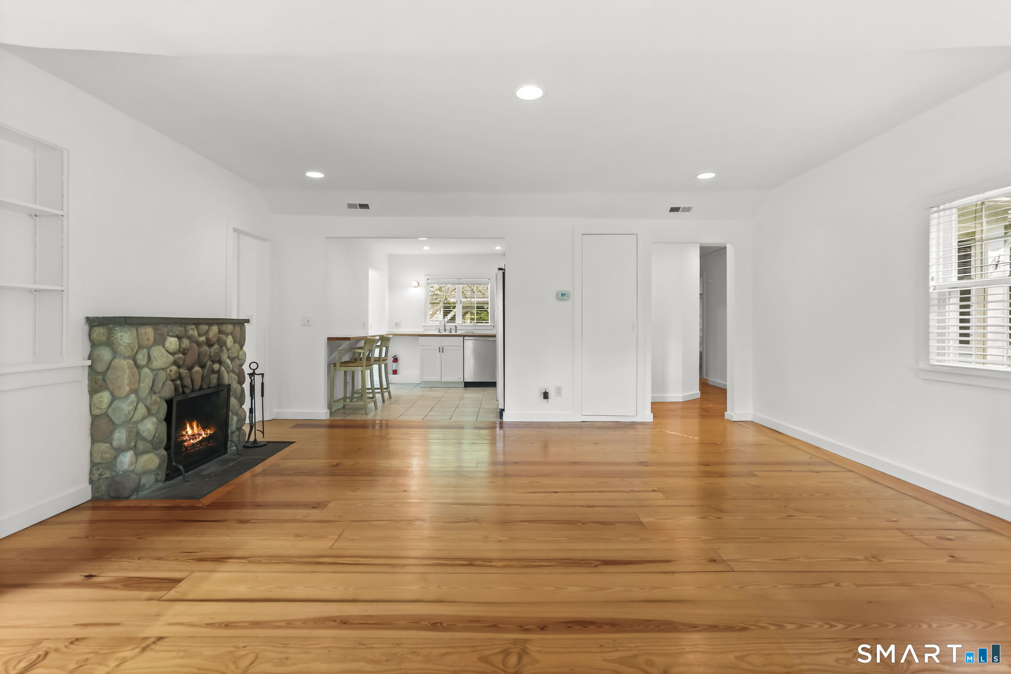4 Topping Lane Norwalk, CT 06854 - Photo 13 of 30 a view of empty room with wooden floor and fireplace