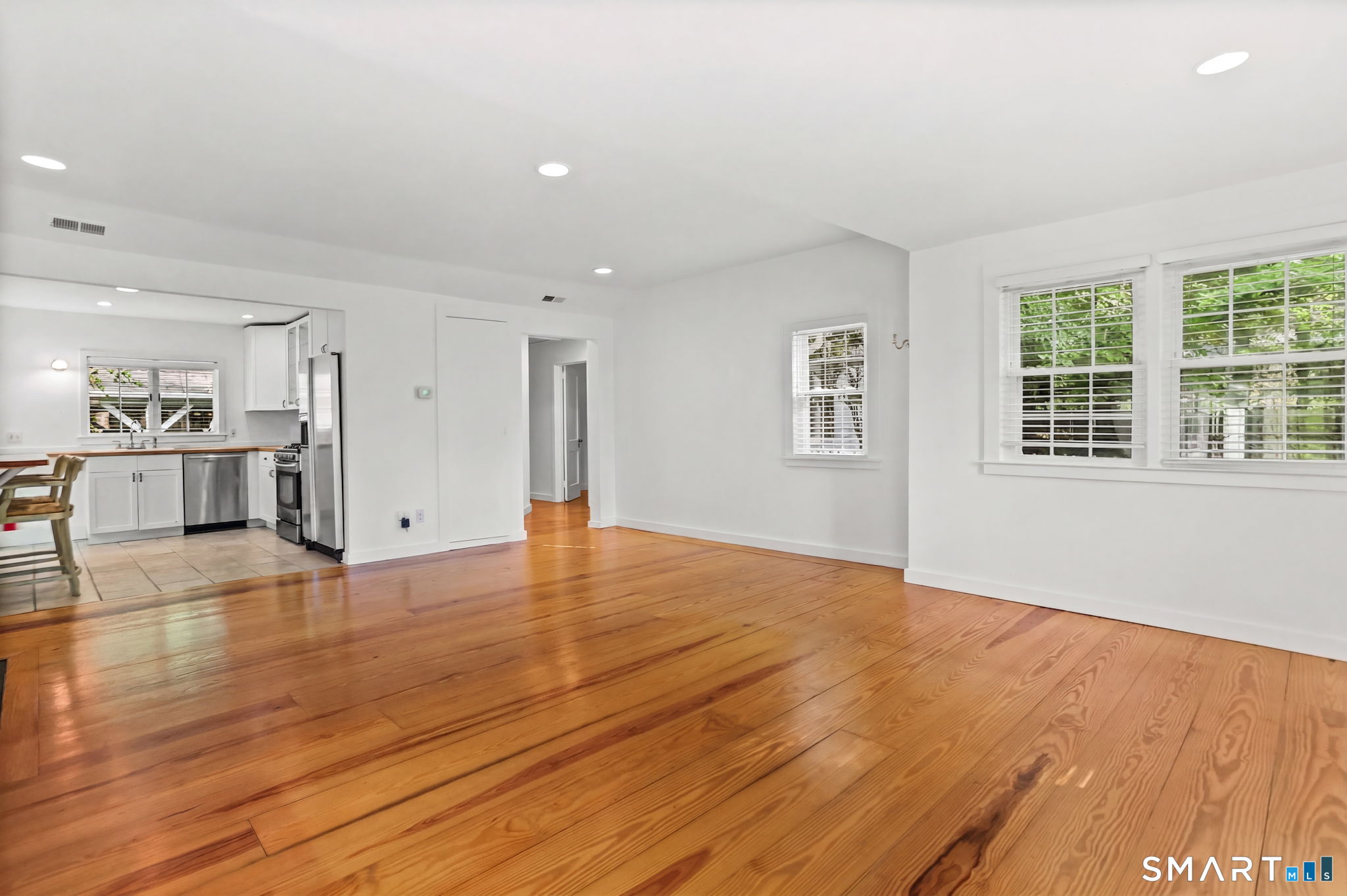 4 Topping Lane Norwalk, CT 06854 - Photo 14 of 30 a view of empty room with wooden floor and windows