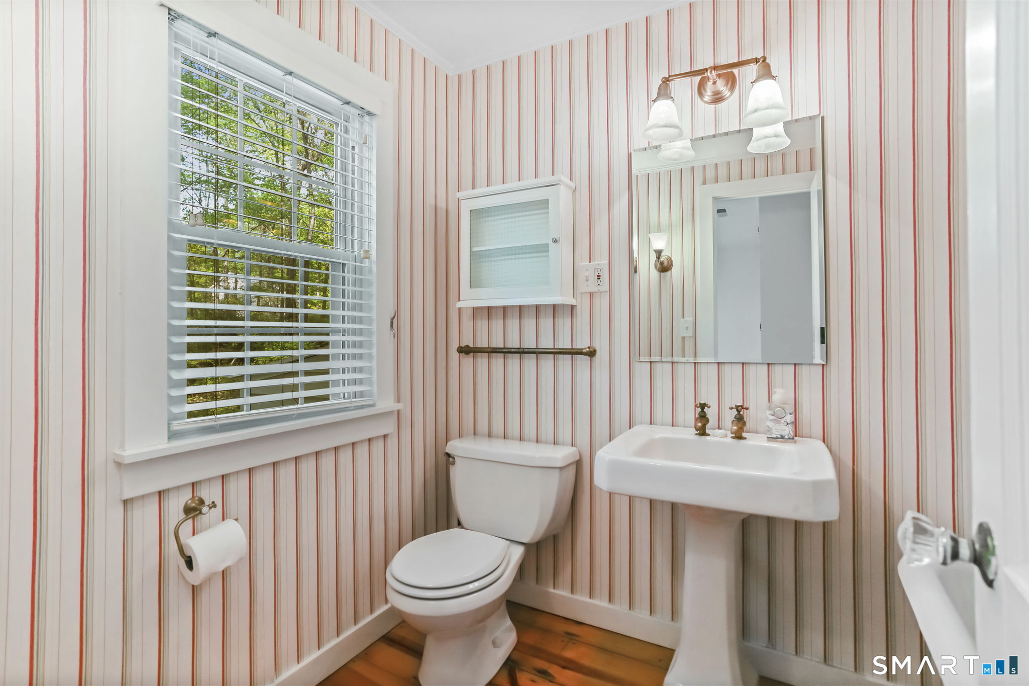 4 Topping Lane Norwalk, CT 06854 - Photo 17 of 30 a bathroom with a sink a toilet and a mirror
