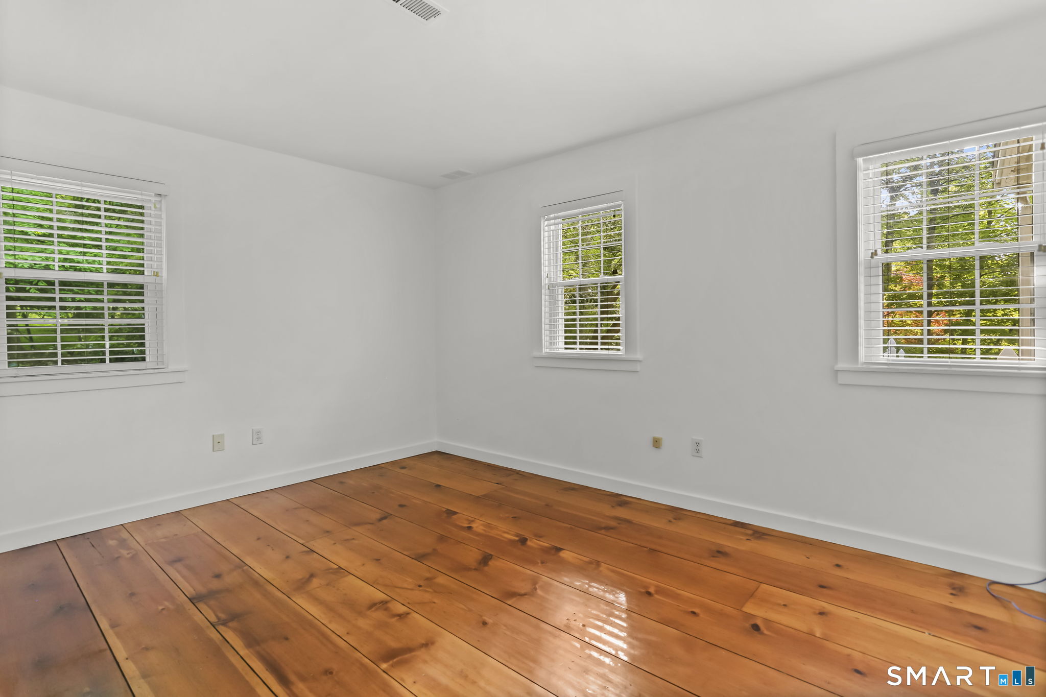 4 Topping Lane Norwalk, CT 06854 - Photo 18 of 30 a view of empty room with wooden floor and fan