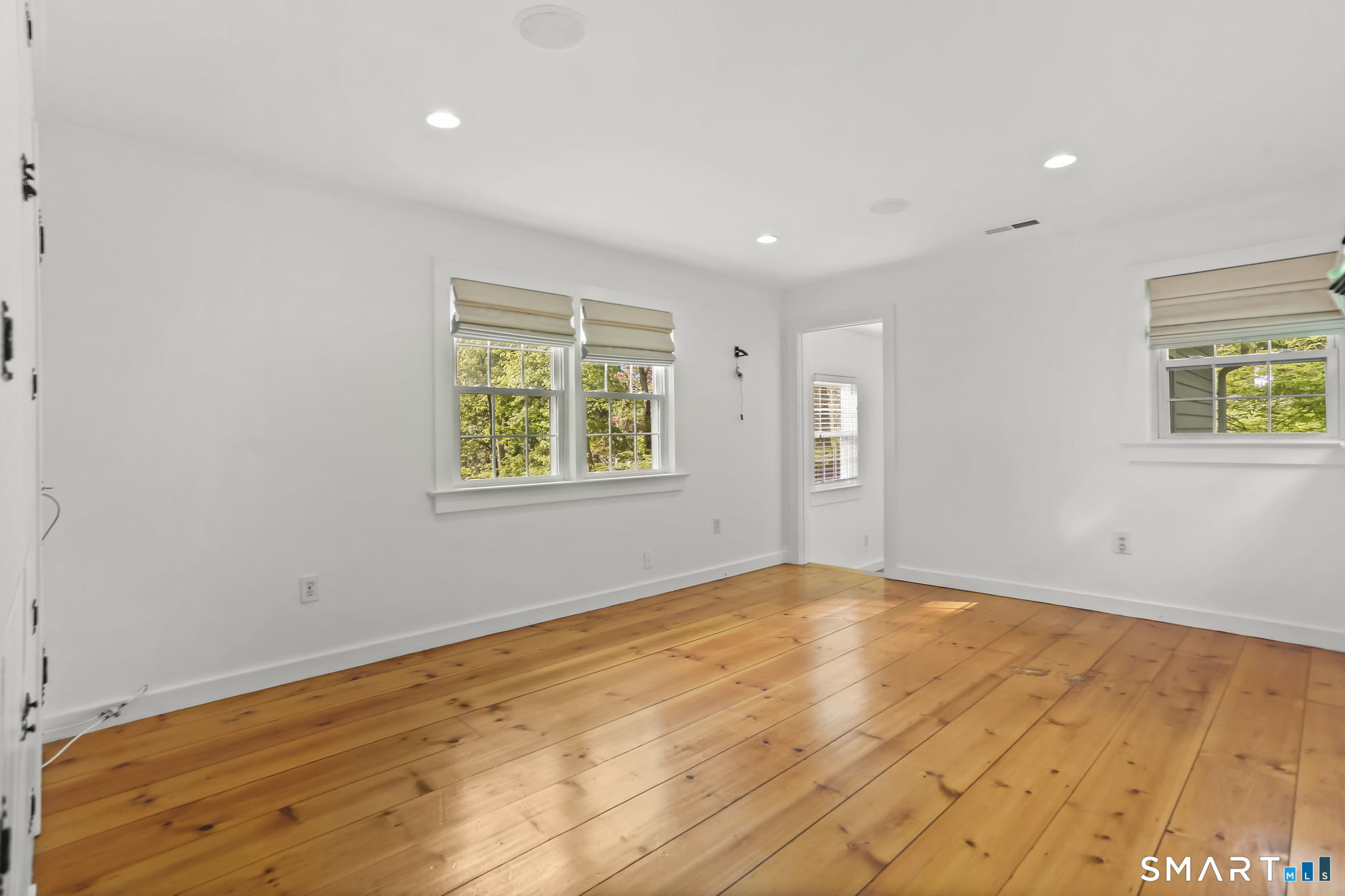 4 Topping Lane Norwalk, CT 06854 - Photo 20 of 30 a view of empty room with wooden floor and fan