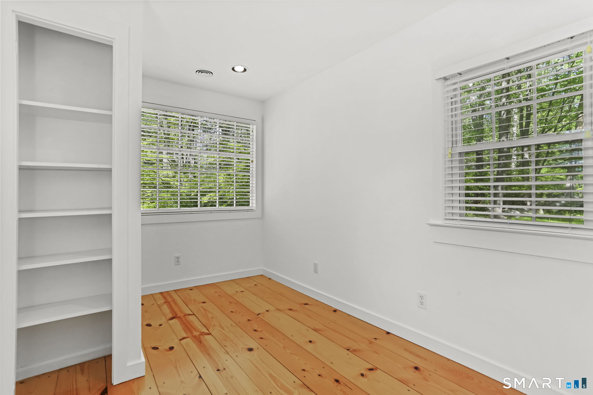 4 Topping Lane Norwalk, CT 06854 - Photo 22 of 30 a view of empty room with wooden floor and fan