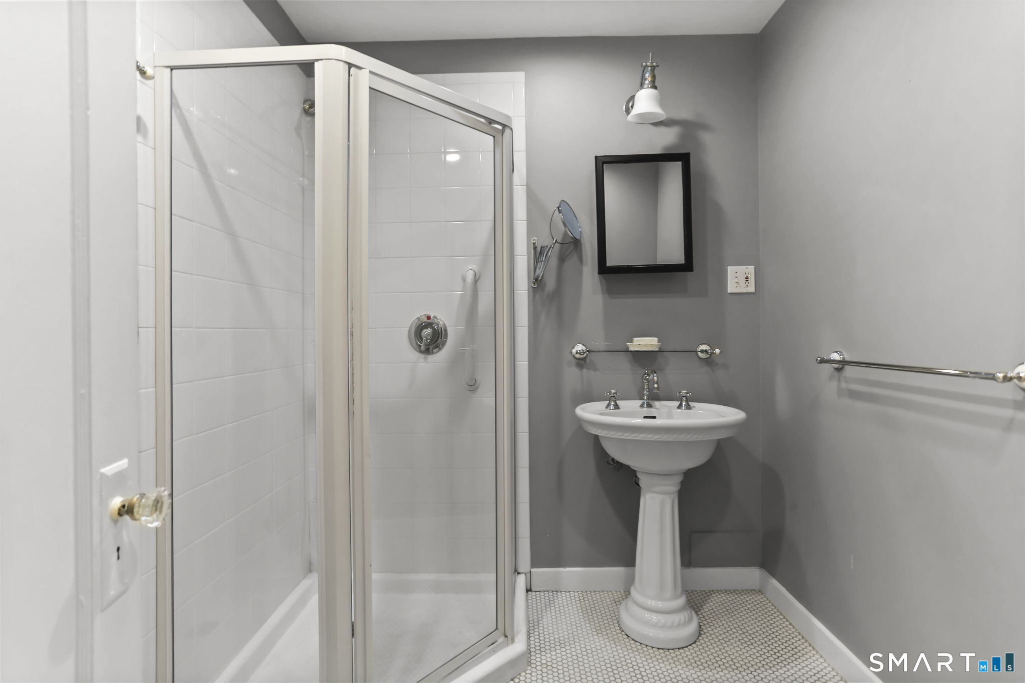 4 Topping Lane Norwalk, CT 06854 - Photo 23 of 30 a bathroom with a sink a mirror and shower