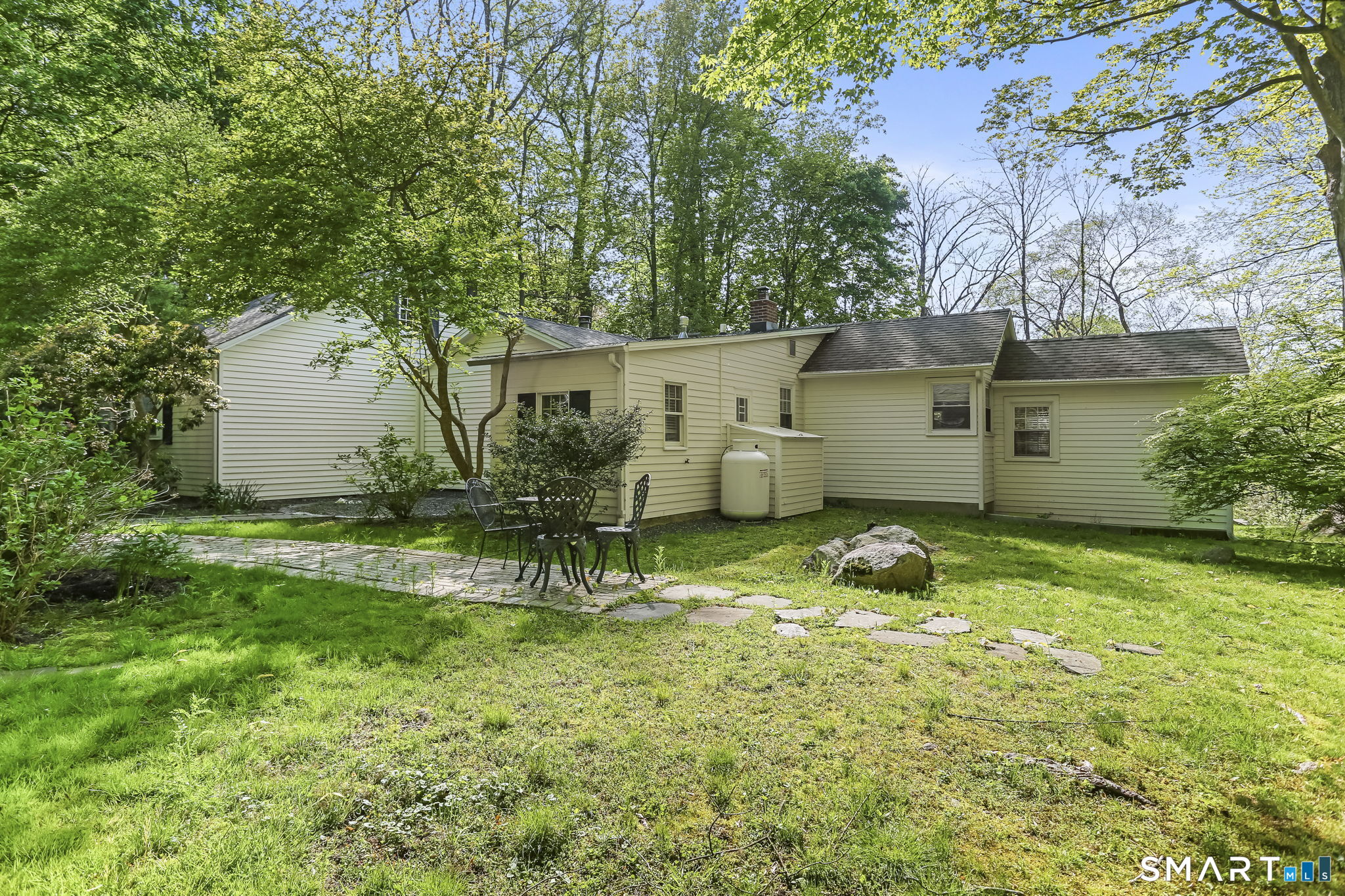 4 Topping Lane Norwalk, CT 06854 - Photo 29 of 30 a view of a backyard with table and chairs and potted plants and large trees