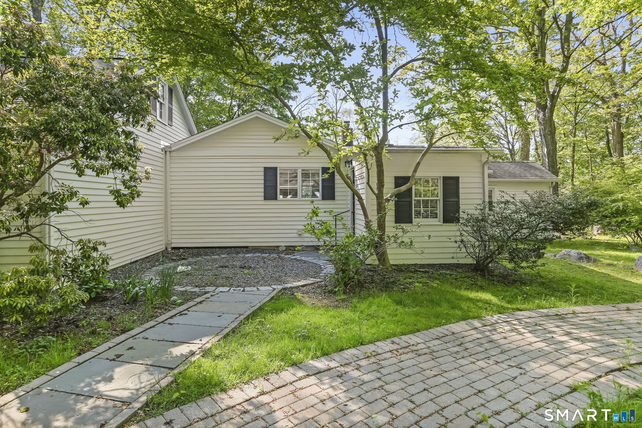 4 Topping Lane Norwalk, CT 06854 - Photo 4 of 30 a view of a white house next to a yard with big trees