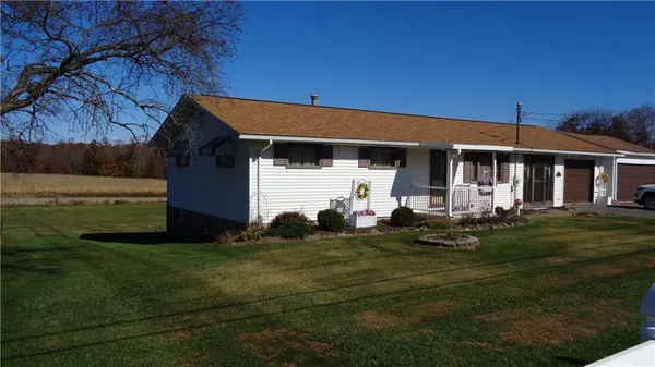 a front view of a house with a garden