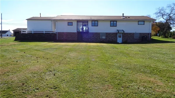 a bed sitting in a bedroom next to a window and a lamp