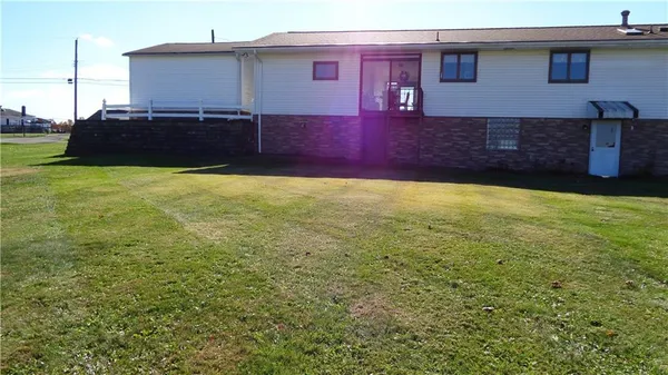 a dining room with furniture and a floor to ceiling window