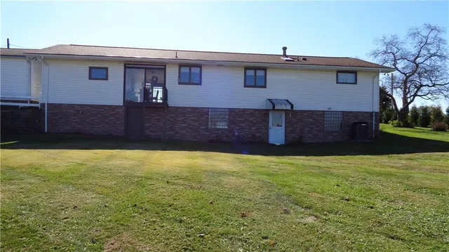 a view of a porch with chairs and backyard