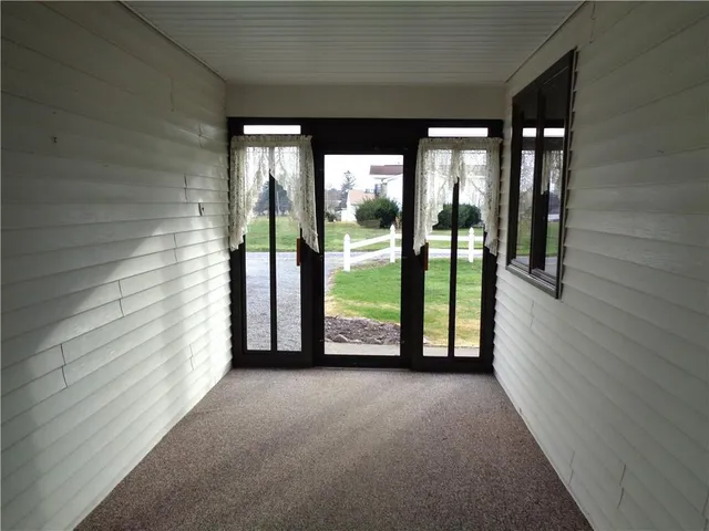 a view of a balcony next to a yard