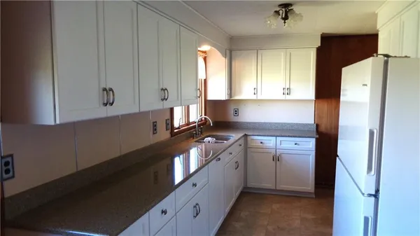 a kitchen with a refrigerator stove and sink