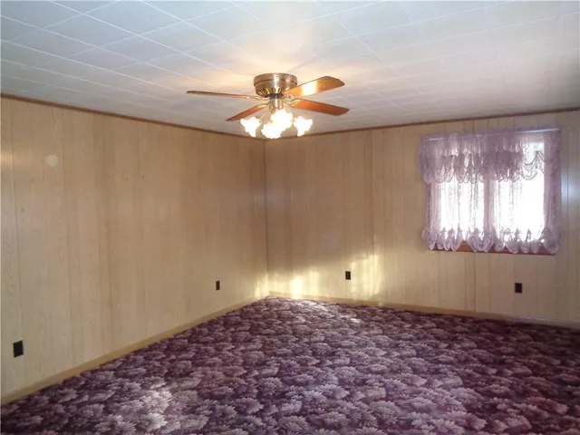 a vase of flowers sitting in a spacious bathroom