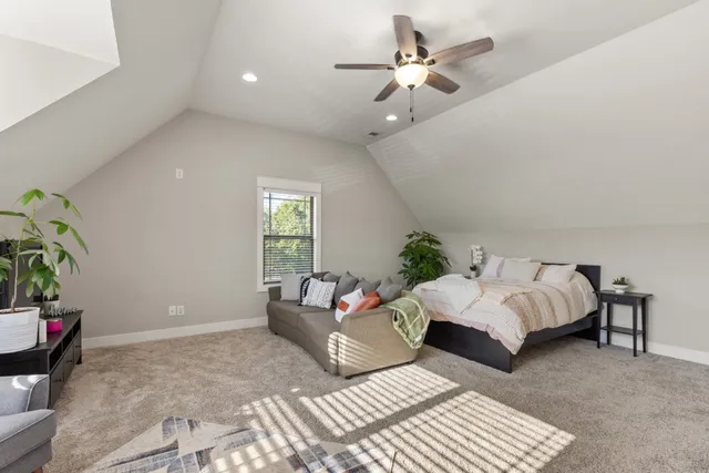a bedroom with a bed ceiling fan and a window