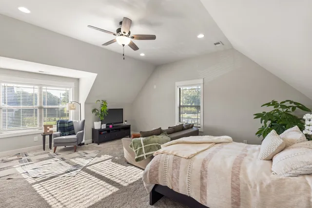 a bedroom with a large bed and a window