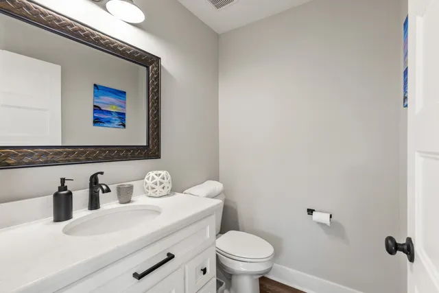 a bathroom with a sink a toilet and a mirror