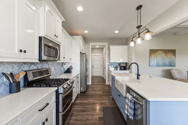 a kitchen with stainless steel appliances a sink stove and refrigerator