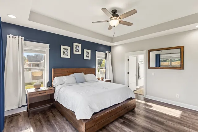 a bedroom with a bed chandelier and a window