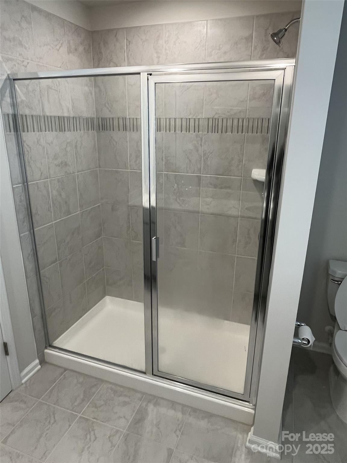 15529 Capps Road Charlotte, NC 28278 - Photo 18 of 27 a bathroom with a glass shower door