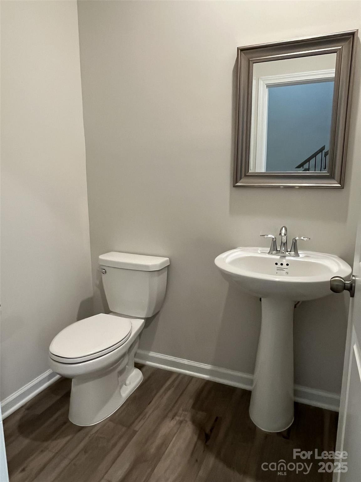 15529 Capps Road Charlotte, NC 28278 - Photo 4 of 27 a bathroom with a toilet sink and mirror