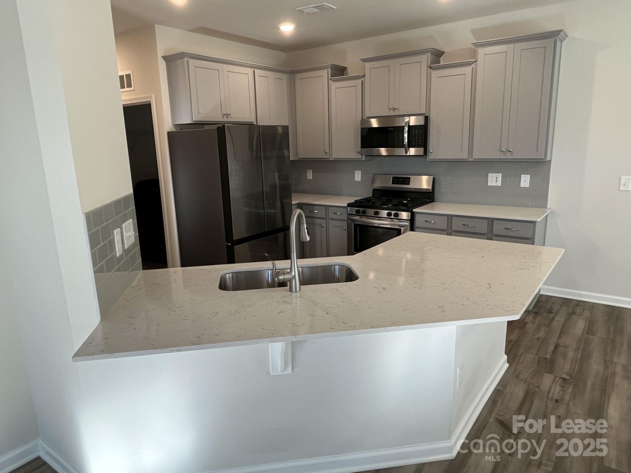 15529 Capps Road Charlotte, NC 28278 - Photo 9 of 27 a kitchen with stainless steel appliances granite countertop a refrigerator a stove a microwave and sink