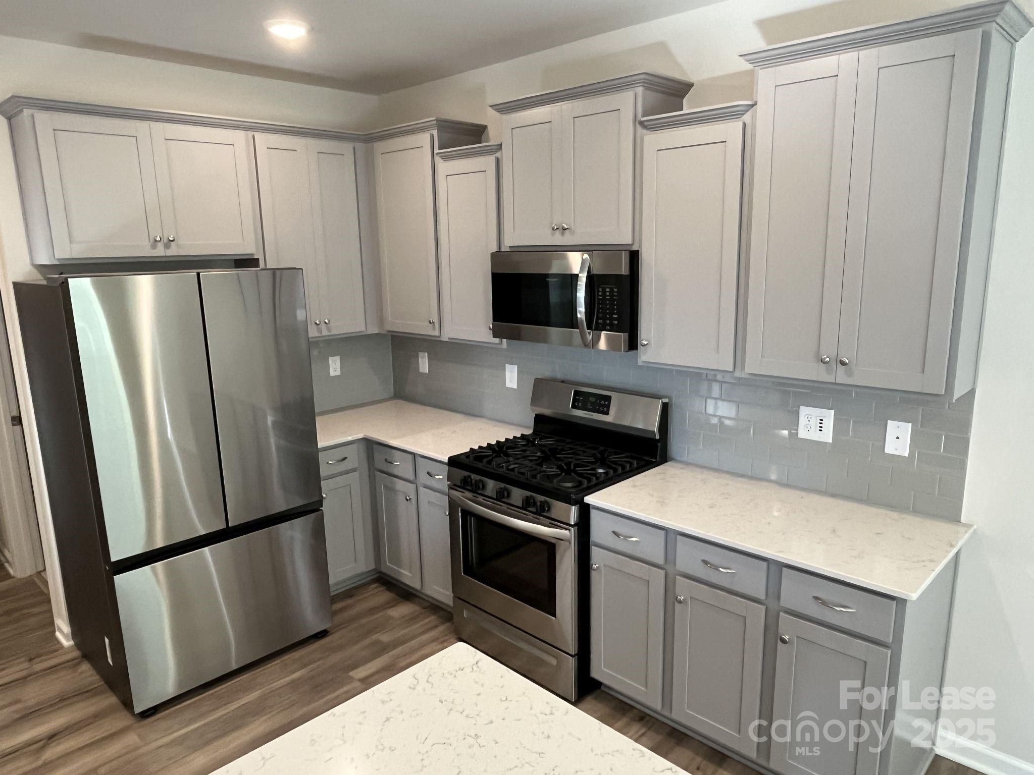 15529 Capps Road Charlotte, NC 28278 - Photo 10 of 27 a kitchen with a refrigerator stove and microwave