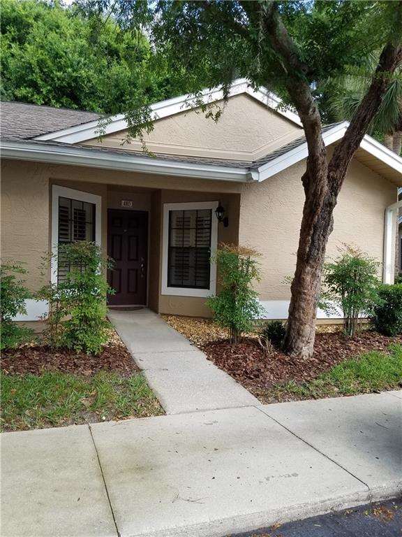 5100 Burchette Road, Unit 4103 Tampa, FL 33647 - Photo 1 of 1 a view of a white house with a tree and plants