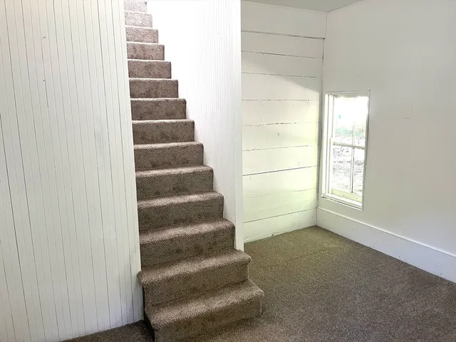 a view of an empty room with stairs