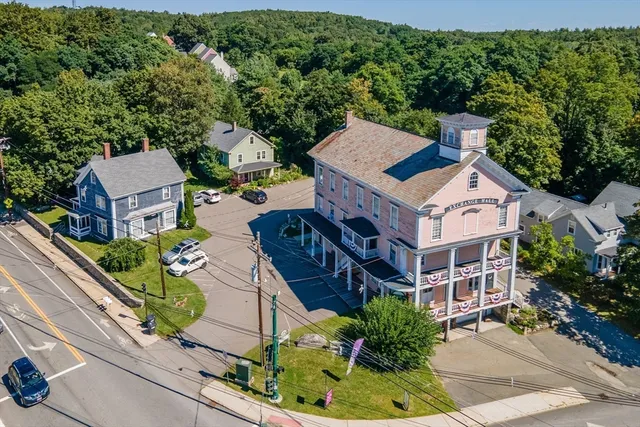 an aerial view of a house with a yard