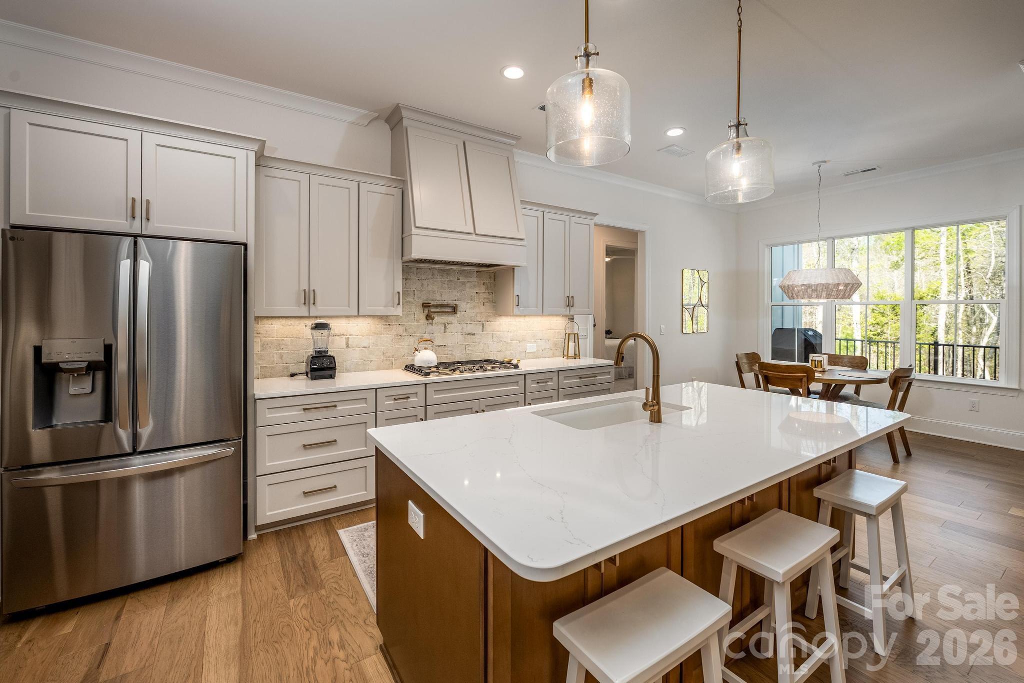 2411 Callaghan Court Landis, NC 28088 - Photo 11 of 48 a kitchen with stainless steel appliances granite countertop a sink a stove a refrigerator and island with wooden floor