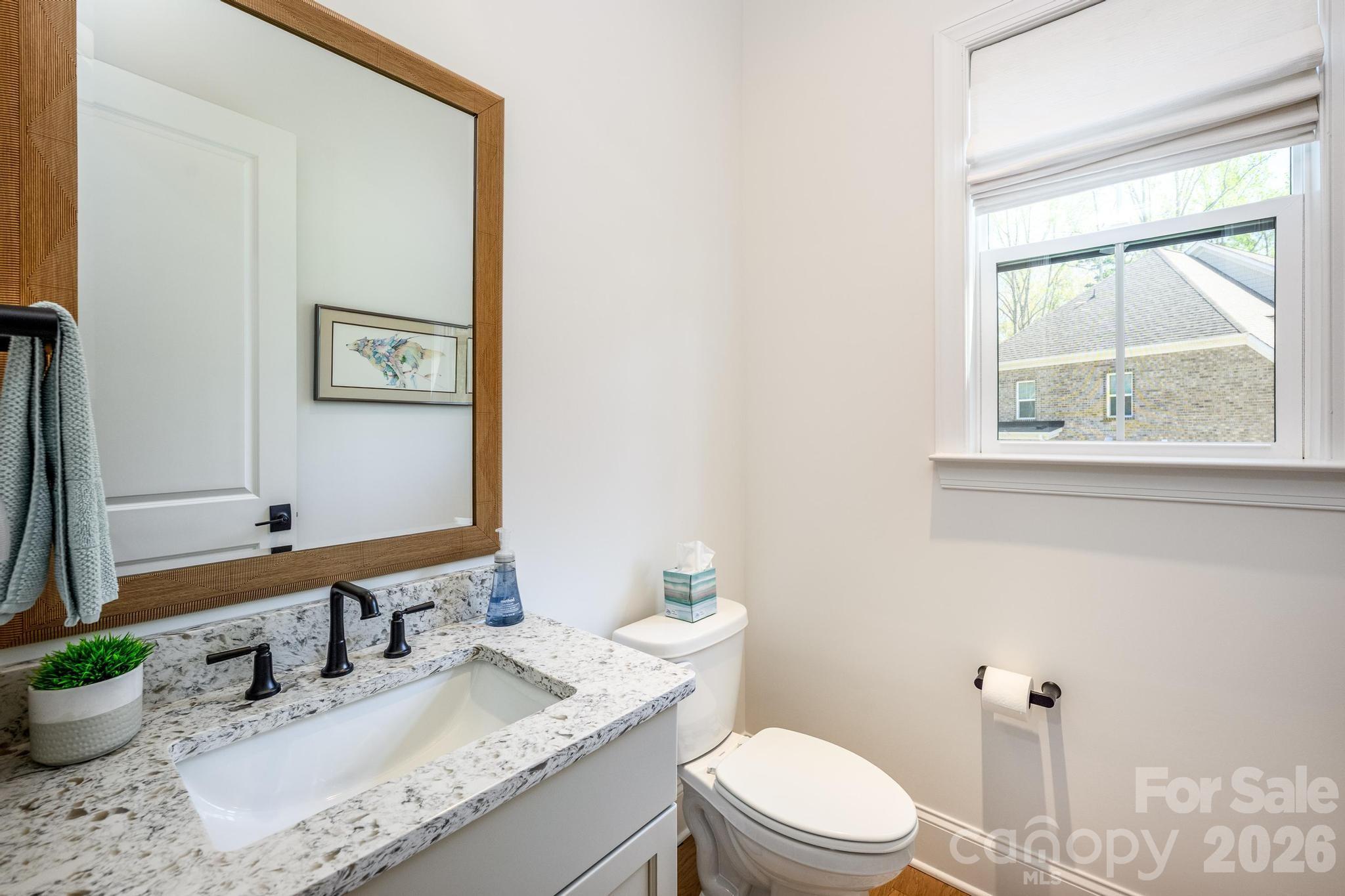 2411 Callaghan Court Landis, NC 28088 - Photo 40 of 48 a bathroom with a granite countertop sink mirror vanity and toilet