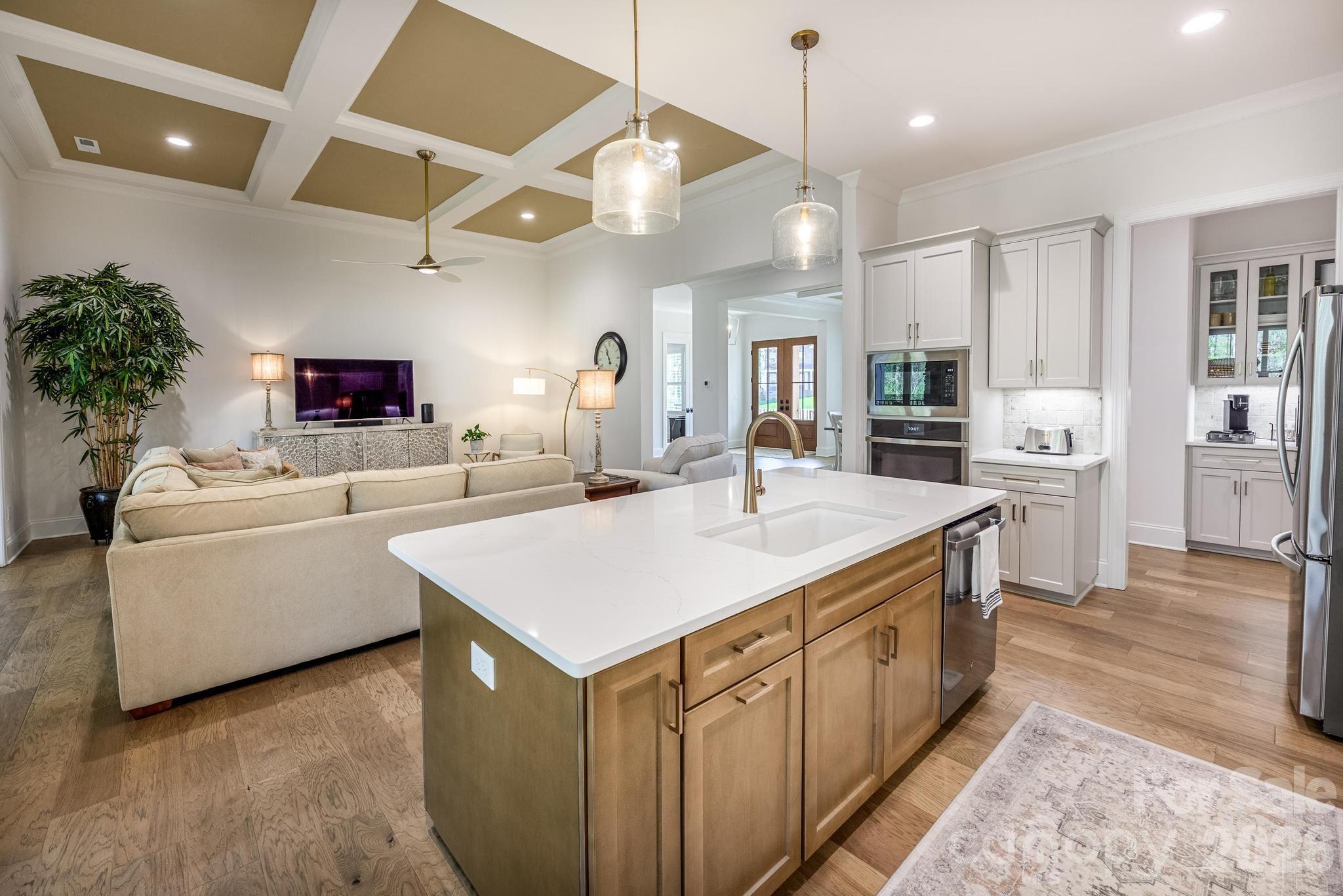 2411 Callaghan Court Landis, NC 28088 - Photo 6 of 48 a large kitchen with kitchen island a sink a counter space and stainless steel appliances