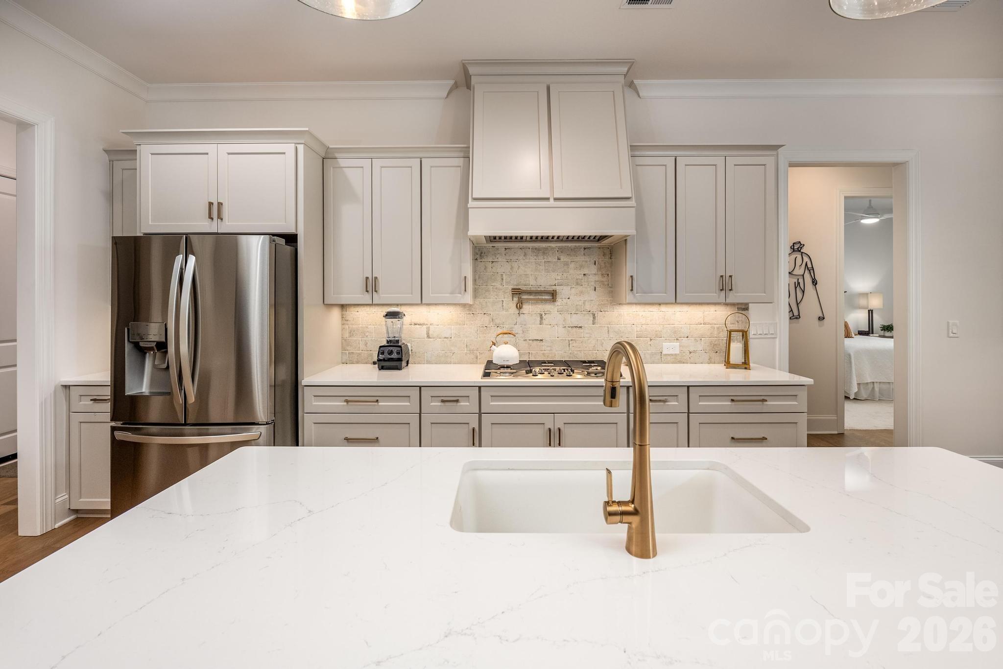 2411 Callaghan Court Landis, NC 28088 - Photo 7 of 48 a kitchen with stainless steel appliances kitchen island granite countertop a refrigerator and a stove top oven