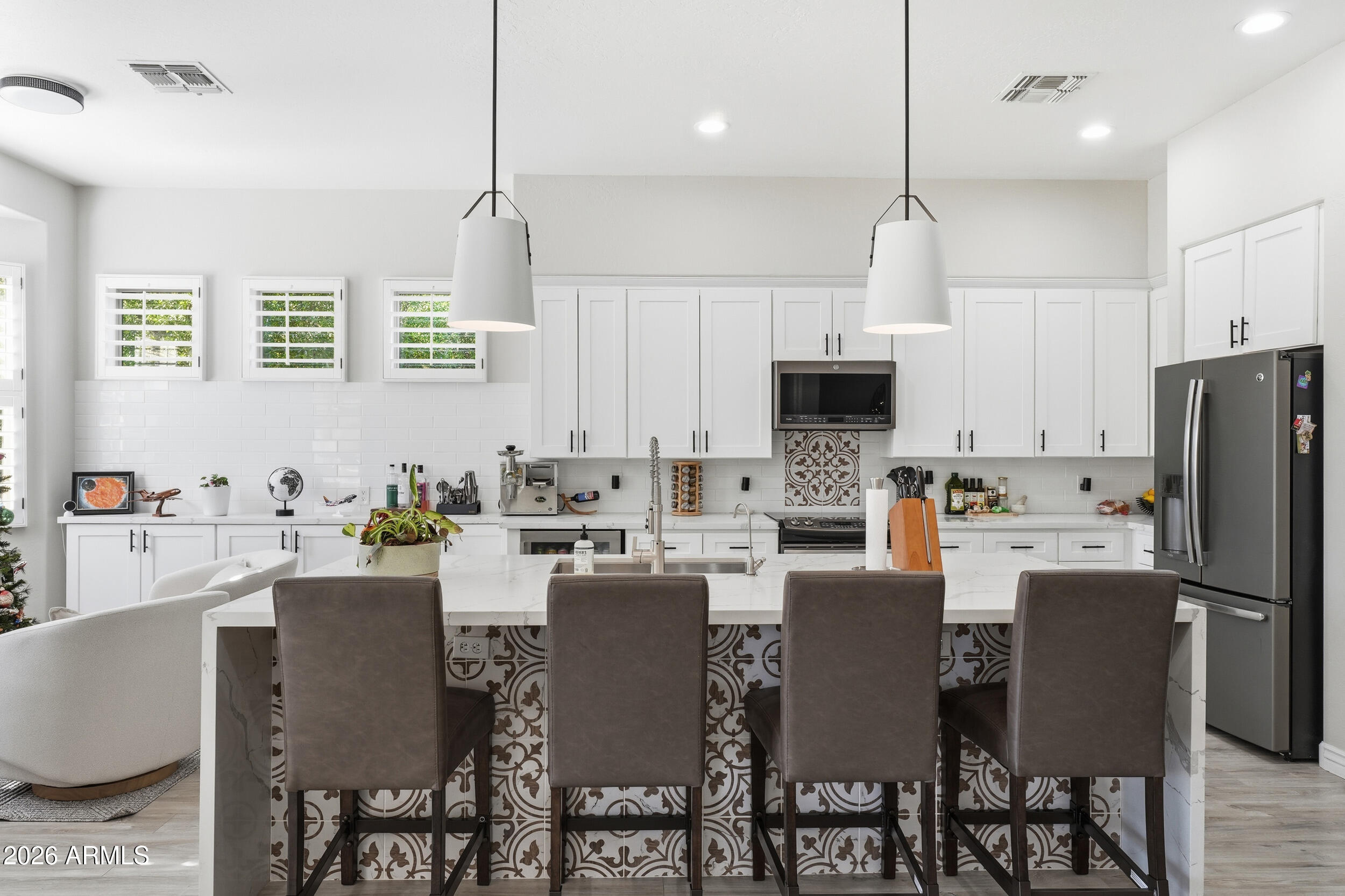 2633 East Fremont Road Phoenix, AZ 85042 - Photo 14 of 43 a dining room with stainless steel appliances kitchen island granite countertop a dining table chairs and a refrigerator