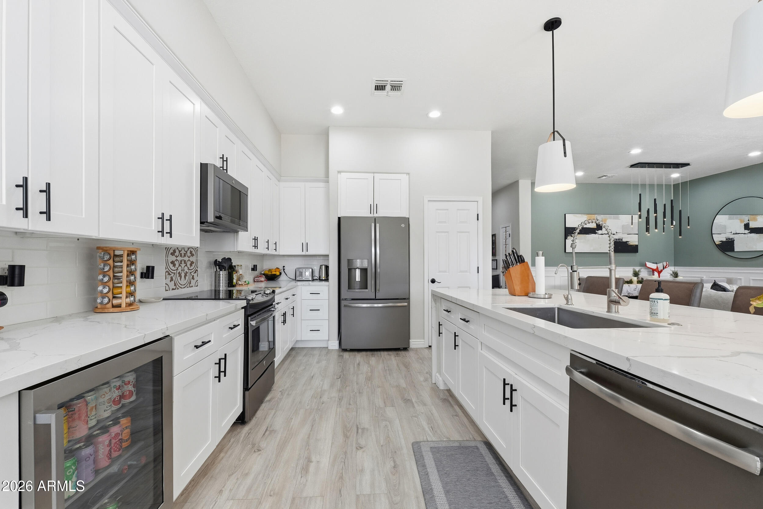 2633 East Fremont Road Phoenix, AZ 85042 - Photo 15 of 43 a kitchen with white cabinets and stainless steel appliances